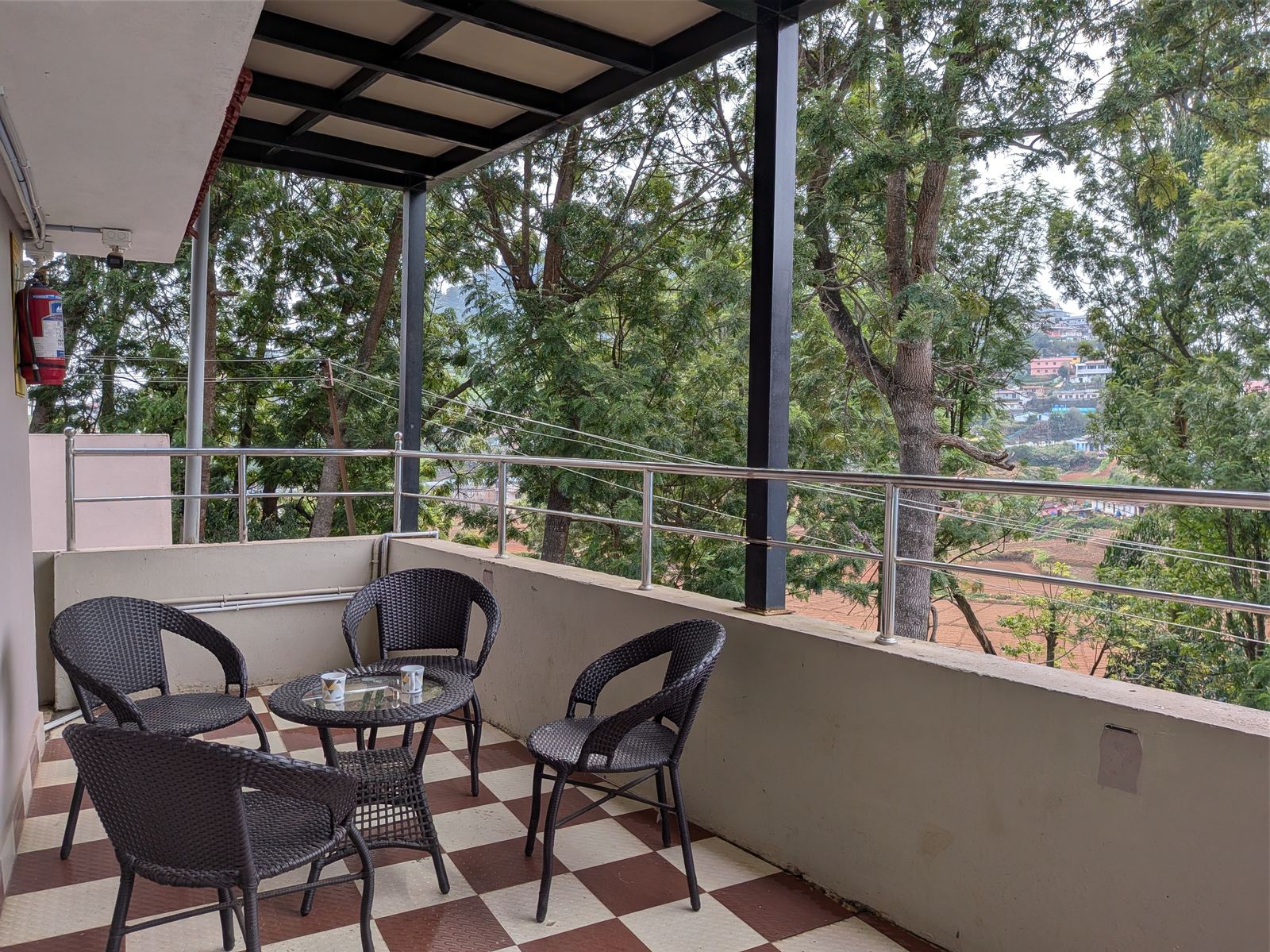View from La Siesta's balcony corridor, overlooking pine trees and the valley