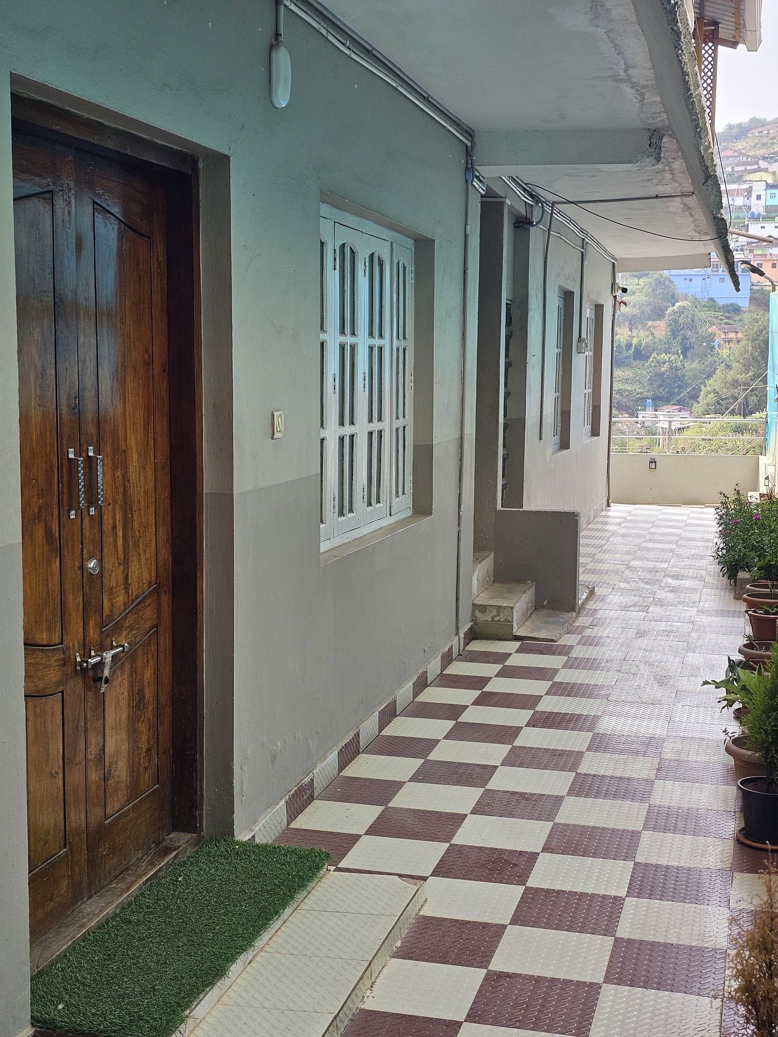 Corridor with checkerboard tile floor leading to the suites