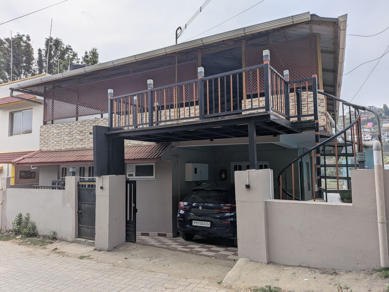 La Siesta Cottage exterior with spiral staircase and covered balcony